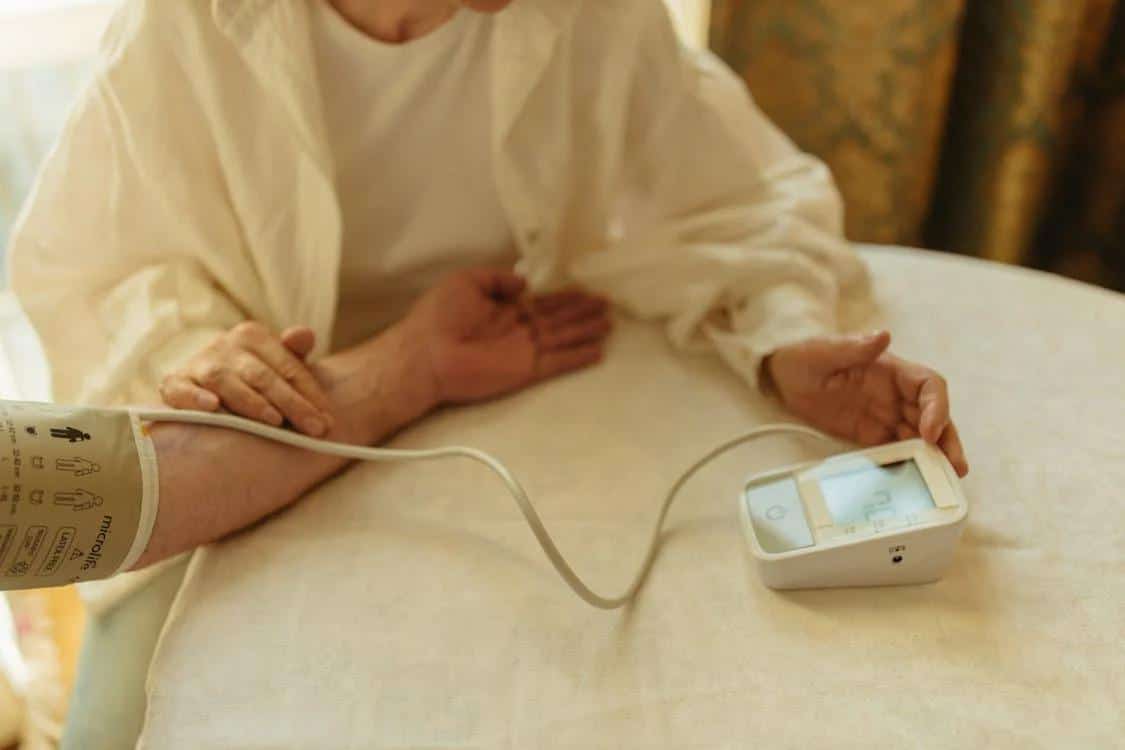 Person using a digital blood pressure monitor at home to measure and track their blood pressure levels.