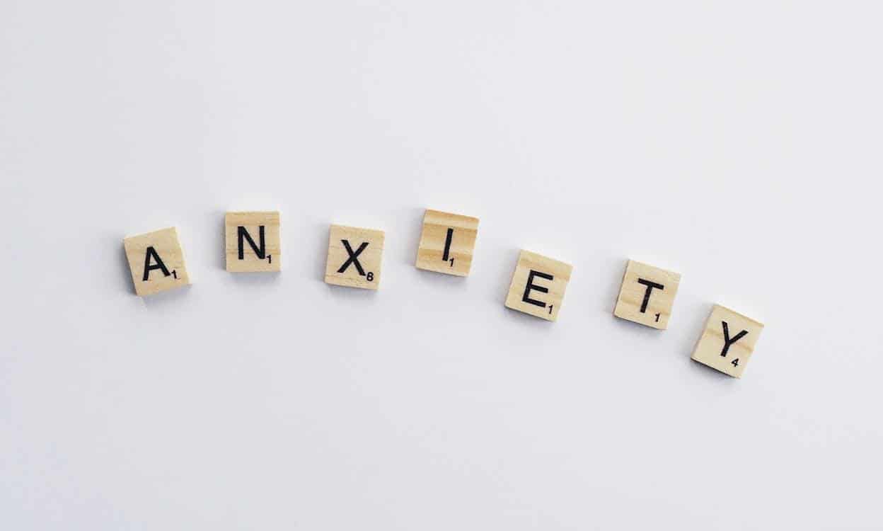 Small wooden letter tiles spelling out the word "anxiety".