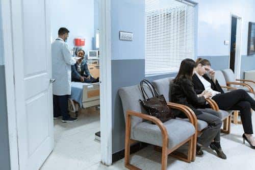 Patients sitting in a medical waiting room waiting for their appointment
