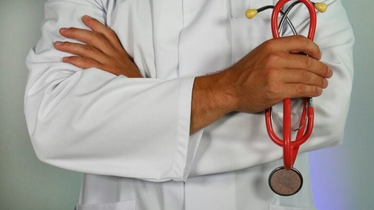 Doctor holding a stethoscope representing routine healthcare care