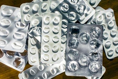 Empty medication blister packs on a table.