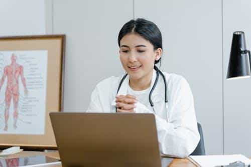 Female doctor speaking with a patient during a telemedicine video consultation