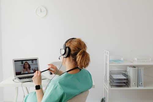 A doctor consulting with a patient via video call in a telehealth session